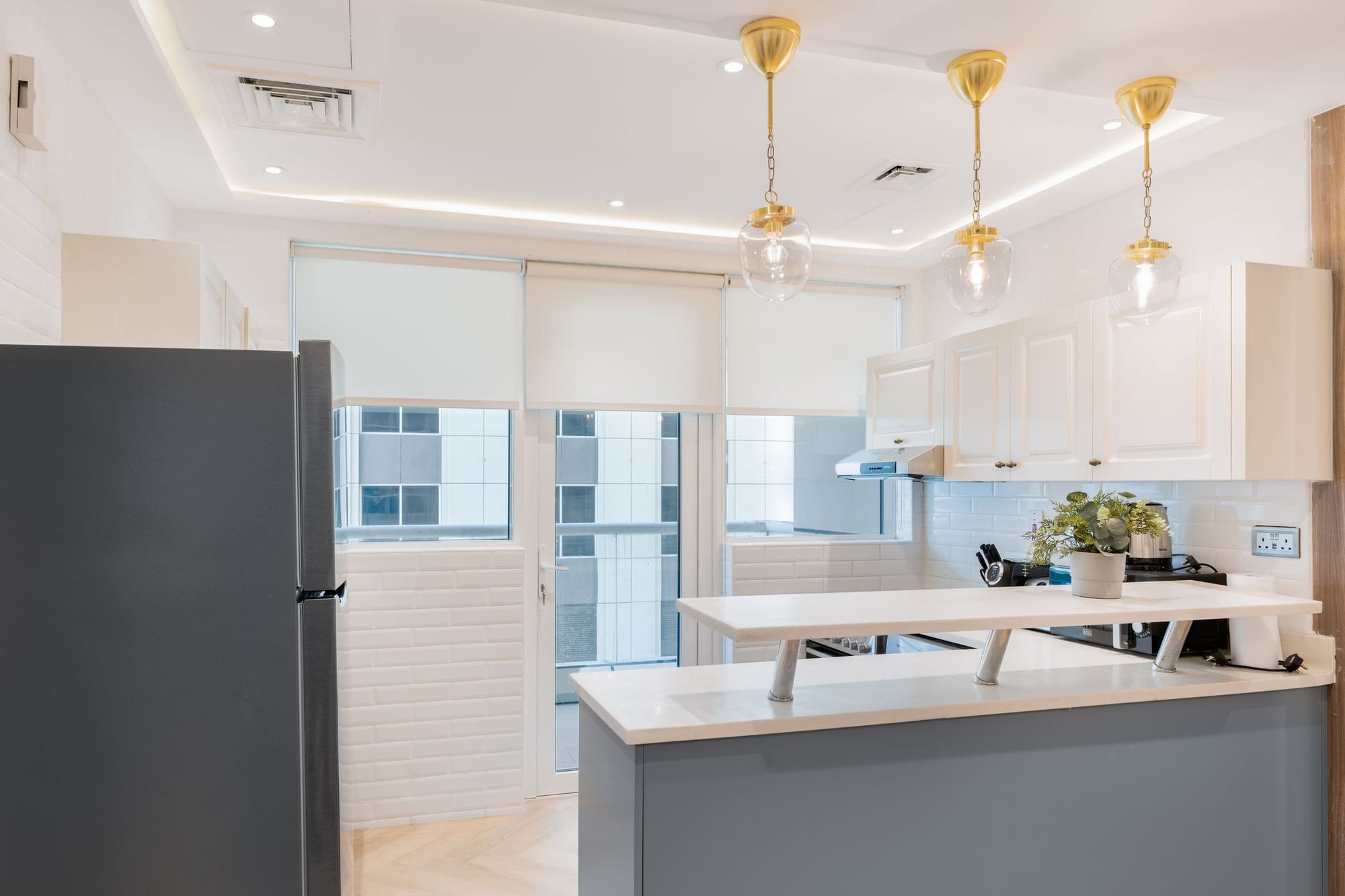 Bright open-plan kitchen with an island and pendant lights